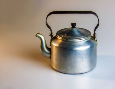 Old soldier's aluminum teapot from the Second World War on a white background.