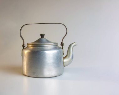 Old soldier's aluminum teapot from the Second World War on a white background.