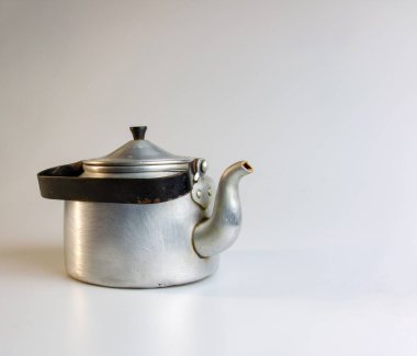 Old soldier's aluminum teapot from the Second World War on a white background.