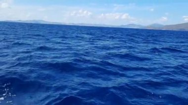 Summer holiday concept. The endless blues of the Aegean. The sun shines brightly and is reflected in the water. Natural sky and horizon background