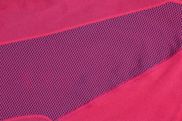 Synthetic fabric texture, red plaid, beautiful background pattern. Fragment of thermal underwear fabric.