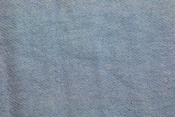 Blue gray fabric texture background. A piece of cotton fabric is carefully laid out on the surface. Textile texture.