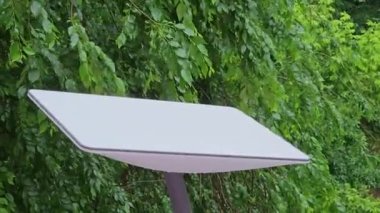 Starlink satellite dish, an internet constellation operated by SpaceX, is installed on the wall of an apartment building.