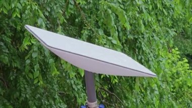 Starlink satellite dish, an internet constellation operated by SpaceX, is installed on the wall of an apartment building.