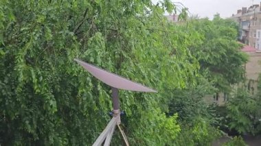 Starlink satellite dish, an internet constellation operated by SpaceX, is installed on the wall of an apartment building.