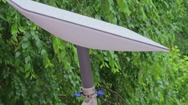 Starlink satellite dish, an internet constellation operated by SpaceX, is installed on the wall of an apartment building.