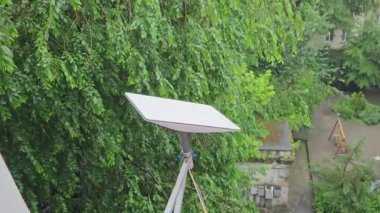 Starlink satellite dish, an internet constellation operated by SpaceX, is installed on the wall of an apartment building.
