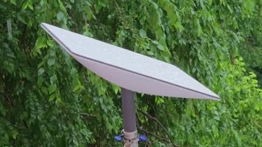 Starlink satellite dish, an internet constellation operated by SpaceX, is installed on the wall of an apartment building.