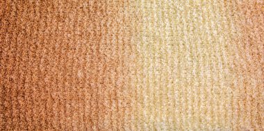 Açık bej kremsi kahverengi tonda arka plan desenli yün kumaş. Doku arka planında bej renk gradyanı. Atkı.