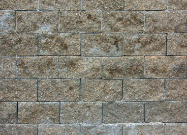 Çakıl taşı rengi taş kaplama fayans duvarı soyut arkaplan. Evin dış tarafı betonla kaplanmış. Dış duvarda el yapımı tuğla işi..