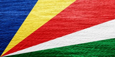 Seyşel Cumhuriyeti bayrağı dokulu bir arka planda. Kavram kolajı.