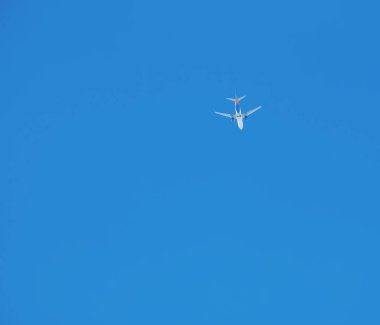 Güneşli bir günde mavi gökyüzünün arka planına karşı bir uçak.