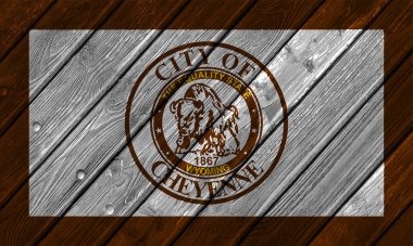 Flag of the city of Cheyenne, Wyoming, USA, on a background of a wooden fence. Conceptual collage. clipart