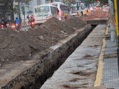 Cordoba, Argentina - May 08, 2025: Laying underground utilities in the city center. Trench and soil dumps for the laying utilities.