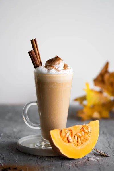 Spicy latte with cinnamon, pumpkin and whipped cream. Pumpkin latte in autumn mood. High quality photo.