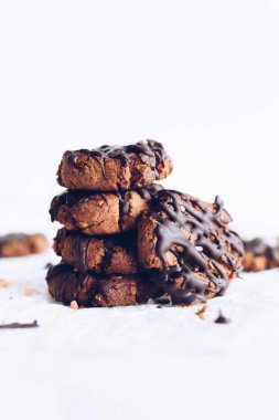 Dark chocolate chip gluten free cookies from almond flour on white background. Close-up tasty bakery organic homemade American biscuit sweet dessert. Copy space. High quality photo.