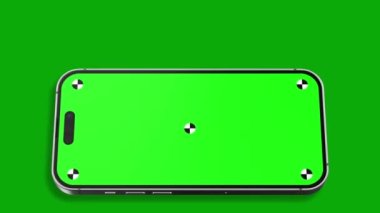 Akıllı telefonun göstergeli boş yeşil ekranı çerçeveye doğru dönüyor. Luma mat, arka plan değişikliği için dahil. Modern çerçevesiz tasarım, hareket bulanıklığı yok ve odaklanma