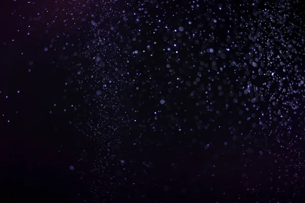 Yüzen parçacıklar. Yüzen toz. Ateş parçacıkları. Siyah arkaplan üzerindeki parçacıklar.