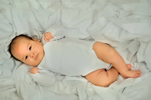 新生児の笑顔と笑い 感情を表す 赤ちゃんは白い布の上に — ストック写真