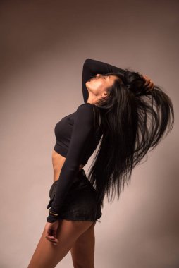 black-haired girl dressed in black shorts and a tank top. sexy ass. wish . excitation.