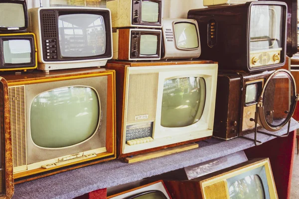 Rows of old TVs.The first televisions are tube-type.Collection Of retro Tv Sets.