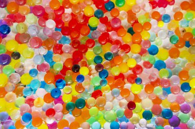 Renkli orbiz 'in geçmişi, toplar. Çok renkli Orbeez 'in doku seti. Orbeez oyun için su boncukları. Birçok renkli yörünge, helyum topları