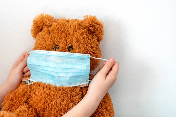 Girl Puts Mask Bear Teddy Bear Protective Mask Concept Care — Stock Photo, Image