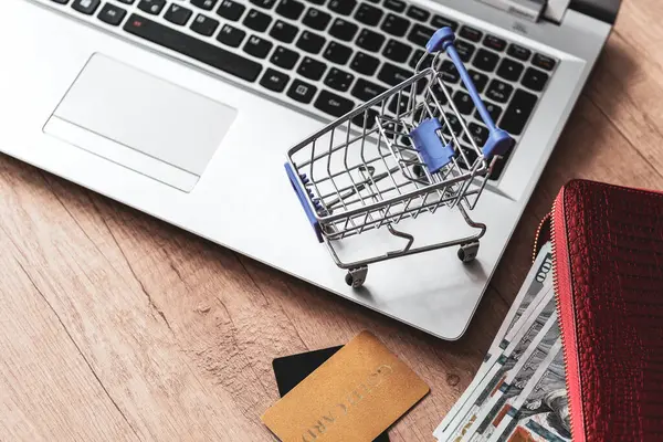 cart on laptop keyboard background. credit card and  wallet with dollars. concept shopping online, Internet sales. Shopping  on The online web.
