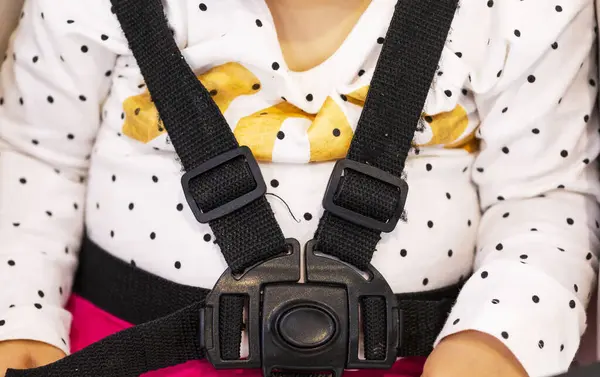 Seat belt in a baby carriage.child seat belts in the car. Close-up Concept Safety and health of children
