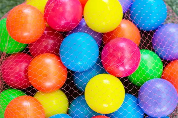 Background of colored balls. The texture is a lot of different color balls. Many  spheres of different sizes. colored balloons