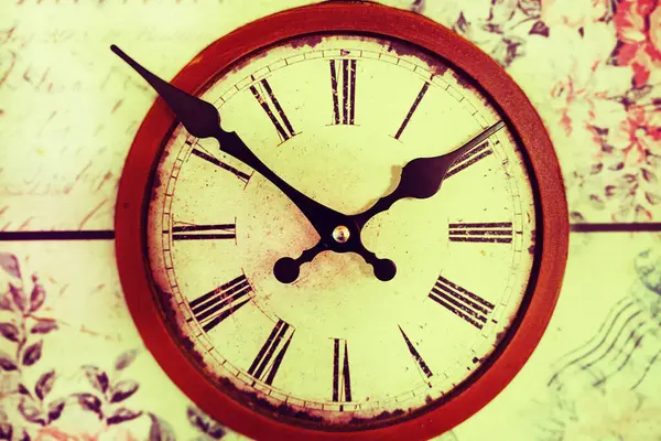 Old vintage clock on a wooden background.  Round dial of the wall clock. Concept Time runs. time concept.  watch, timepiece, timer, timekeeper, ticker.