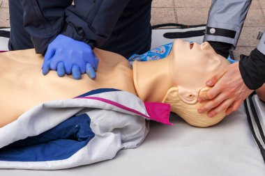 Diriltme egzersizi sırasında manken üzerindeki bir polis memurunun elleri. Kalp masajı ilk yardım eğitim konsepti. Acil bakım..
