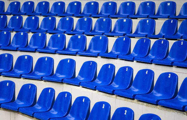 Stands.seats. dark blue seats at stadium. Tribune of fans at the sports ground. semi-turn view