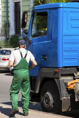 Şoför arabanın yanında. Tankı olan bir araba. Meslek sürücüsü konsepti.