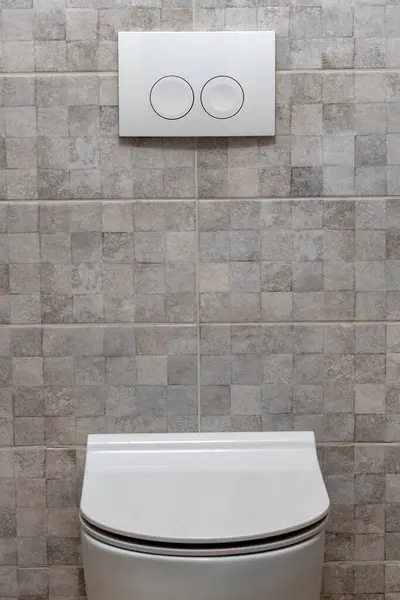 Toilet bowl button on the wall. Copy space. toilet with two separate buttons. Modern toilet design Hygiene Concept. close-up