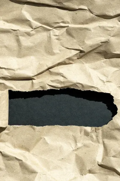 hole in paper with  color paper background inside. Good paper texture.torn hole in paper.pape