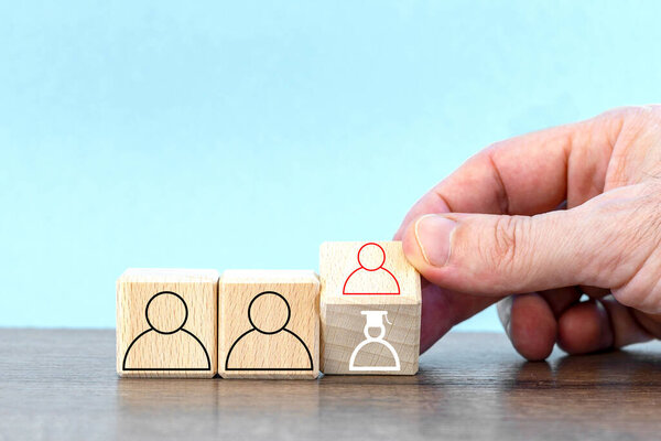 hand keep cube with symbol a person. Appointment of a new manager, team leader. Promotion, career advancement concept