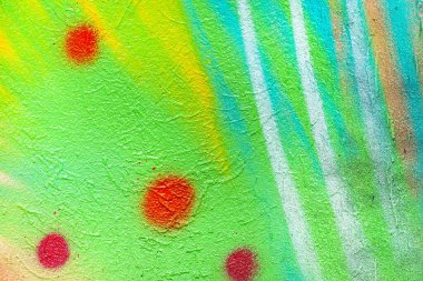 Duvar pembe ve yeşil, turuncu renklerle boyanmış. Renkli bir duvarın dokusu. Soyut arkaplan