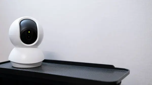 stock image Selective focus of Smart home wireless security camera set up on white table at home, using for security monitoring or private cctv