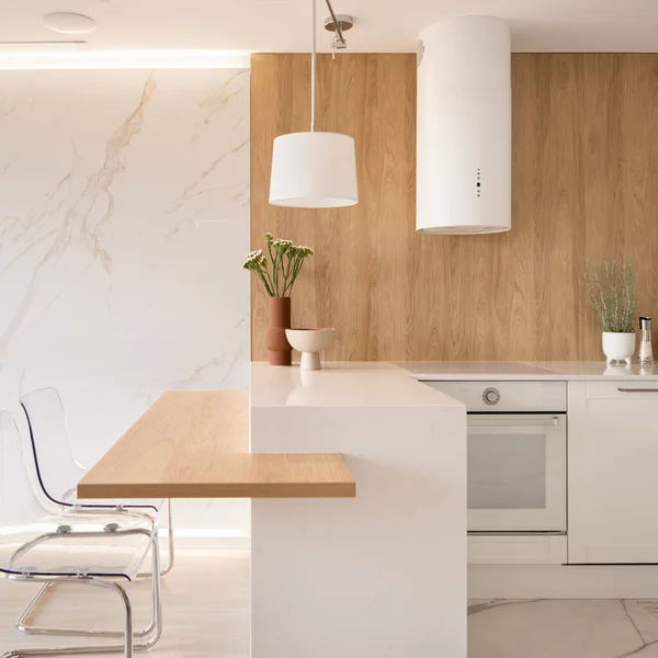 Aesthetic kitchen with white marble on wall and floor, wooden countertop and backsplash wall and white furniture