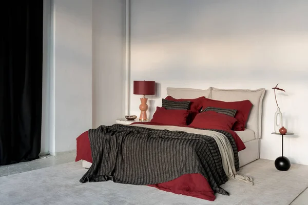 Spacious Bedroom Black Red Orange Colors Bedclothes Lamp Decorations lizenzfreie Stockbilder