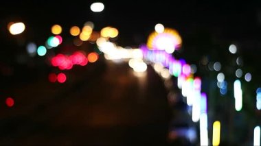 Blur night colorful light of traffic and vehicle on main road near shopping mall in pattaya city