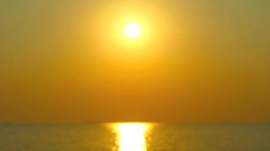blur gold sunset on the sea and shining reflection of sunlight on the water surface