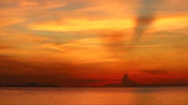 Dark red cloud on sunset sky colorful hot tone cloud over sea and sun ray background