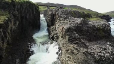 İzlanda 'da büyük bir nehir, temiz soğuk su, büyük bir şelale, dinlenecek bir yer, helikopterden bir manzara.