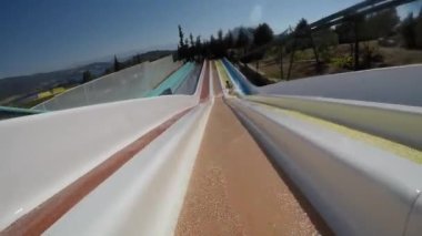 Descent from the slide in the water park, rapid descent, front view