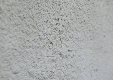 Wall background, grainy gray plaster, concrete texture, close-up.