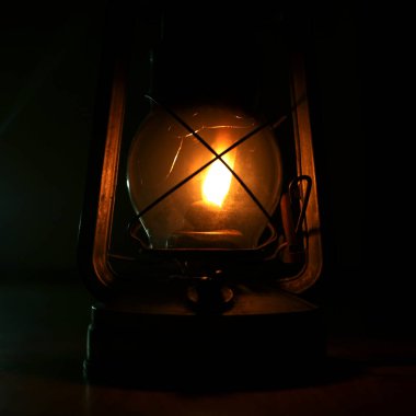 An old kerosene lamp is a light in the dark. There is no electricity