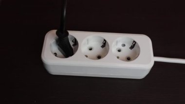 Socket with three connectors for equipment. The carrier is white