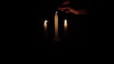 Lighting candles in the dark. When there is no electricity.